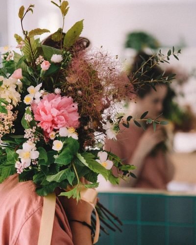 woman holding pink and white flowers