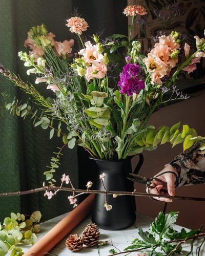 white and purple flowers in black vase